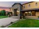 Exterior shot of property at sunset showcasing stone entry with manicured landscaping at 21962 E Diana Way, Queen Creek, AZ 85142