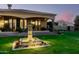 An amazing property featuring a beautiful fountain, landscaping, and stunning architecture against a sunset backdrop at 21962 E Diana Way, Queen Creek, AZ 85142