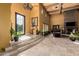 Elegant foyer with stone steps, a decorative iron door and chandelier at 21962 E Diana Way, Queen Creek, AZ 85142