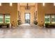 Spacious foyer featuring tile flooring, iron door, chandelier and decorative plants at 21962 E Diana Way, Queen Creek, AZ 85142