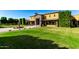 Beautiful home featuring a stone entryway, fountain, and manicured landscaping at 21962 E Diana Way, Queen Creek, AZ 85142