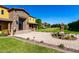Beautiful home featuring a stone entryway, fountain, and manicured lawn at 21962 E Diana Way, Queen Creek, AZ 85142