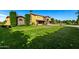 Beautiful home featuring a stone entryway, manicured lawn and landscaped yard at 21962 E Diana Way, Queen Creek, AZ 85142