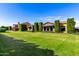 Expansive front yard with manicured lawn and mature landscaping frames a luxury home at 21962 E Diana Way, Queen Creek, AZ 85142
