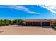 Spacious three-car garage with a paved driveway and manicured landscaping at 21962 E Diana Way, Queen Creek, AZ 85142
