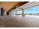 Large garage with open doors, showcasing the paver flooring and exterior views, perfect for car enthusiasts at 21962 E Diana Way, Queen Creek, AZ 85142