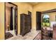 Hallway with decorative armoire, bathroom entry, and exterior view at 21962 E Diana Way, Queen Creek, AZ 85142