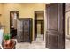 Hallway with travertine floors, decorative armoire, and walk-in closet at 21962 E Diana Way, Queen Creek, AZ 85142