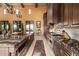 Gourmet kitchen with stainless steel appliances, long island, and dark brown cabinetry at 21962 E Diana Way, Queen Creek, AZ 85142