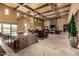 Open concept living area featuring travertine floors, island kitchen, dining area, and living room at 21962 E Diana Way, Queen Creek, AZ 85142