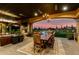 An amazing outdoor living room and dining area featuring a fireplace with sunset backdrop at 21962 E Diana Way, Queen Creek, AZ 85142