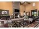 Comfortable living room with stone fireplace, travertine floors and comfortable seating at 21962 E Diana Way, Queen Creek, AZ 85142