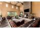 Bright living room boasting a stone fireplace, high ceilings, travertine flooring, and large windows at 21962 E Diana Way, Queen Creek, AZ 85142