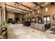 Spacious living room featuring tile flooring, beamed ceilings, and fireplace at 21962 E Diana Way, Queen Creek, AZ 85142