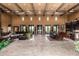 Spacious living room featuring tile flooring, beamed ceilings and large windows at 21962 E Diana Way, Queen Creek, AZ 85142