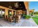 The covered outdoor dining area has custom lighting and is perfect for entertaining at 21962 E Diana Way, Queen Creek, AZ 85142
