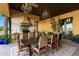 This outdoor dining area features a built-in kitchen with a grill and tiled backsplash at 21962 E Diana Way, Queen Creek, AZ 85142