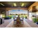 The outdoor kitchen has an open-air dining area with a view of the backyard at 21962 E Diana Way, Queen Creek, AZ 85142