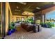 The covered patio area offers a relaxing space with comfortable seating and an outdoor fireplace at 21962 E Diana Way, Queen Creek, AZ 85142