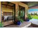 Covered patio featuring an outdoor seating area, access to the yard, and lush landscaping at 21962 E Diana Way, Queen Creek, AZ 85142