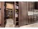 Walk-in pantry with storage shelves and custom cabinetry for all your gourmet needs at 21962 E Diana Way, Queen Creek, AZ 85142