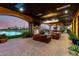 Inviting outdoor patio with comfortable seating, fireplace, tv, pool and elegant lighting, ideal for relaxation and entertaining at 21962 E Diana Way, Queen Creek, AZ 85142
