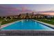 An amazing property featuring a beautiful pool, fountains, and stunning architecture against a sunset backdrop at 21962 E Diana Way, Queen Creek, AZ 85142