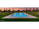 Stunning pool area with manicured lawn, lounge chairs, and a fire pit, creating a luxurious outdoor retreat at 21962 E Diana Way, Queen Creek, AZ 85142
