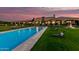 An amazing property featuring a beautiful pool, fountains, and lounge chairs against a sunset backdrop at 21962 E Diana Way, Queen Creek, AZ 85142