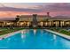 An amazing property featuring a beautiful pool, fountains, and stunning architecture against a sunset backdrop at 21962 E Diana Way, Queen Creek, AZ 85142