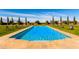 A luxurious pool with fountains and lounge chairs surrounded by a lush lawn and trees at 21962 E Diana Way, Queen Creek, AZ 85142