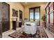 Relaxing room with massage table, decorative touches, and outdoor views at 21962 E Diana Way, Queen Creek, AZ 85142