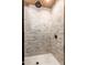 Walk-in shower tiled with natural stone and rain shower head at 21962 E Diana Way, Queen Creek, AZ 85142