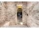 Spacious shower with elegant stone tiles and built in bench at 21962 E Diana Way, Queen Creek, AZ 85142