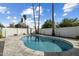 Inviting backyard pool featuring a large pool with a stone-tile deck, block wall, and mature landscaping at 2256 S Noche De Paz --, Mesa, AZ 85202