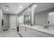 Bright bathroom features double vanity, white cabinetry, quartz countertops, and decorative mirrors at 2256 S Noche De Paz --, Mesa, AZ 85202