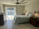 Bright bedroom featuring a ceiling fan and sliding glass doors with pool view at 2256 S Noche De Paz --, Mesa, AZ 85202