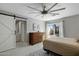 Bright bedroom featuring tile floors, a ceiling fan, and sliding glass doors to the outdoor patio at 2256 S Noche De Paz --, Mesa, AZ 85202