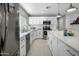 Well-lit kitchen featuring stainless steel appliances, white cabinetry, and tiled backsplash at 2256 S Noche De Paz --, Mesa, AZ 85202