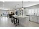 Modern kitchen featuring a large center island with seating, stainless steel appliances, and open dining area at 2256 S Noche De Paz --, Mesa, AZ 85202