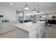 Open kitchen with white cabinets, stainless steel appliances, and a view to the living room at 2256 S Noche De Paz --, Mesa, AZ 85202