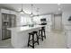 Modern kitchen with stainless steel appliances, a large island, and three pendant lights at 2256 S Noche De Paz --, Mesa, AZ 85202