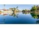 Picturesque lake view with mature trees and community homes in the background at 2256 S Noche De Paz --, Mesa, AZ 85202