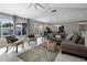 Spacious living room with large windows, a ceiling fan, a sectional sofa, and access to the backyard at 2256 S Noche De Paz --, Mesa, AZ 85202