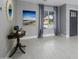 Comfortable living room featuring a front door entrance, light gray walls, tile floors, and bright window at 2256 S Noche De Paz --, Mesa, AZ 85202