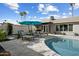 Inviting pool area with lounge chairs and patio umbrella for relaxing in the sun at 2256 S Noche De Paz --, Mesa, AZ 85202