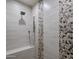 Modern tiled shower with built in bench and modern fixtures, creating a spa-like experience at 2256 S Noche De Paz --, Mesa, AZ 85202
