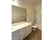 Bathroom featuring a sink, a toilet, and a shower with a white tile surround at 236 N Wesley --, Mesa, AZ 85207