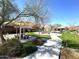 Charming community area with covered seating, picnic tables, and lush landscaping for gathering at 236 N Wesley --, Mesa, AZ 85207