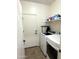 Functional laundry room with washer, dryer, and storage shelving for convenience at 236 N Wesley --, Mesa, AZ 85207